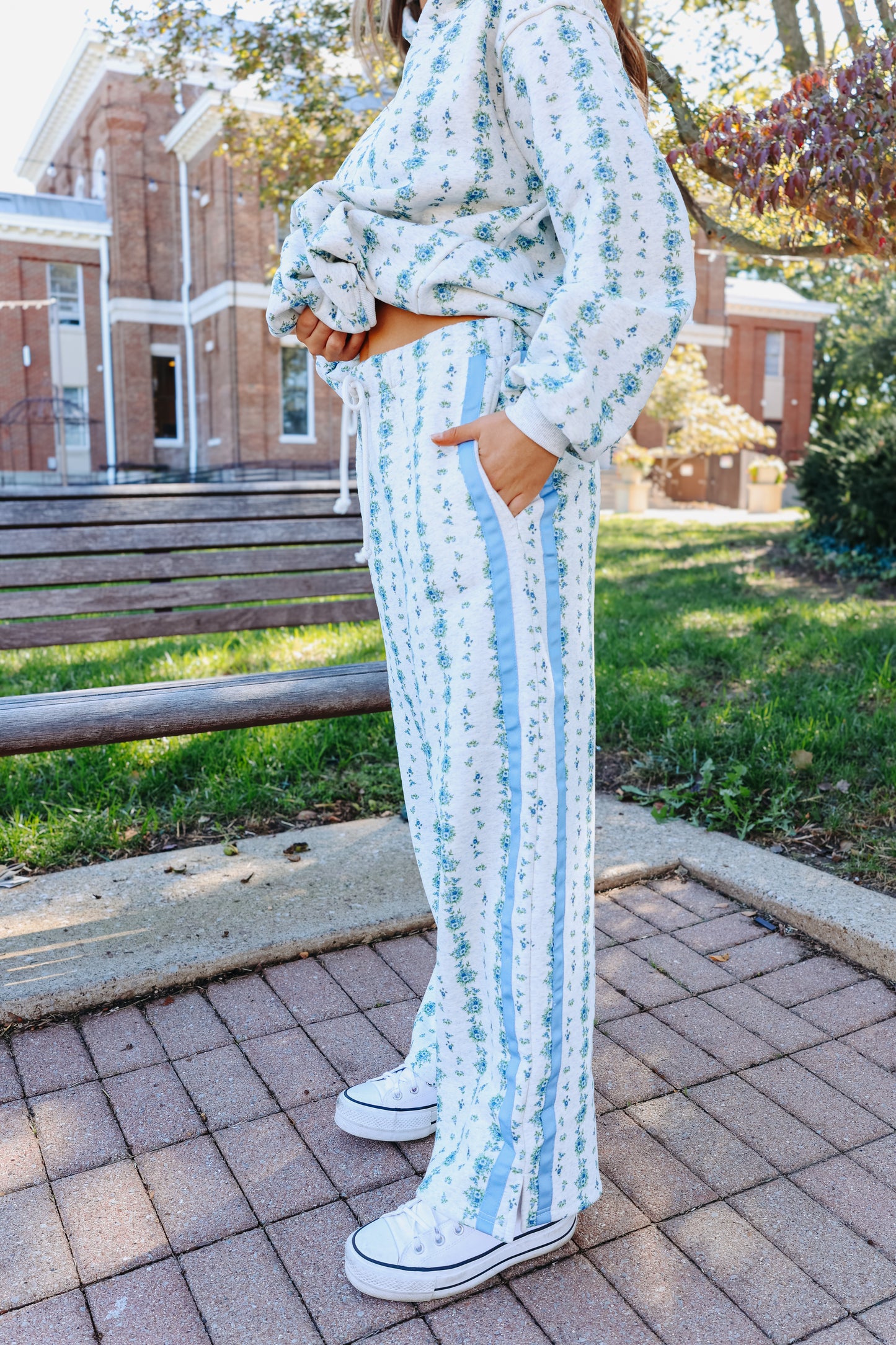 Model wearing blue floral striped lounge pants.