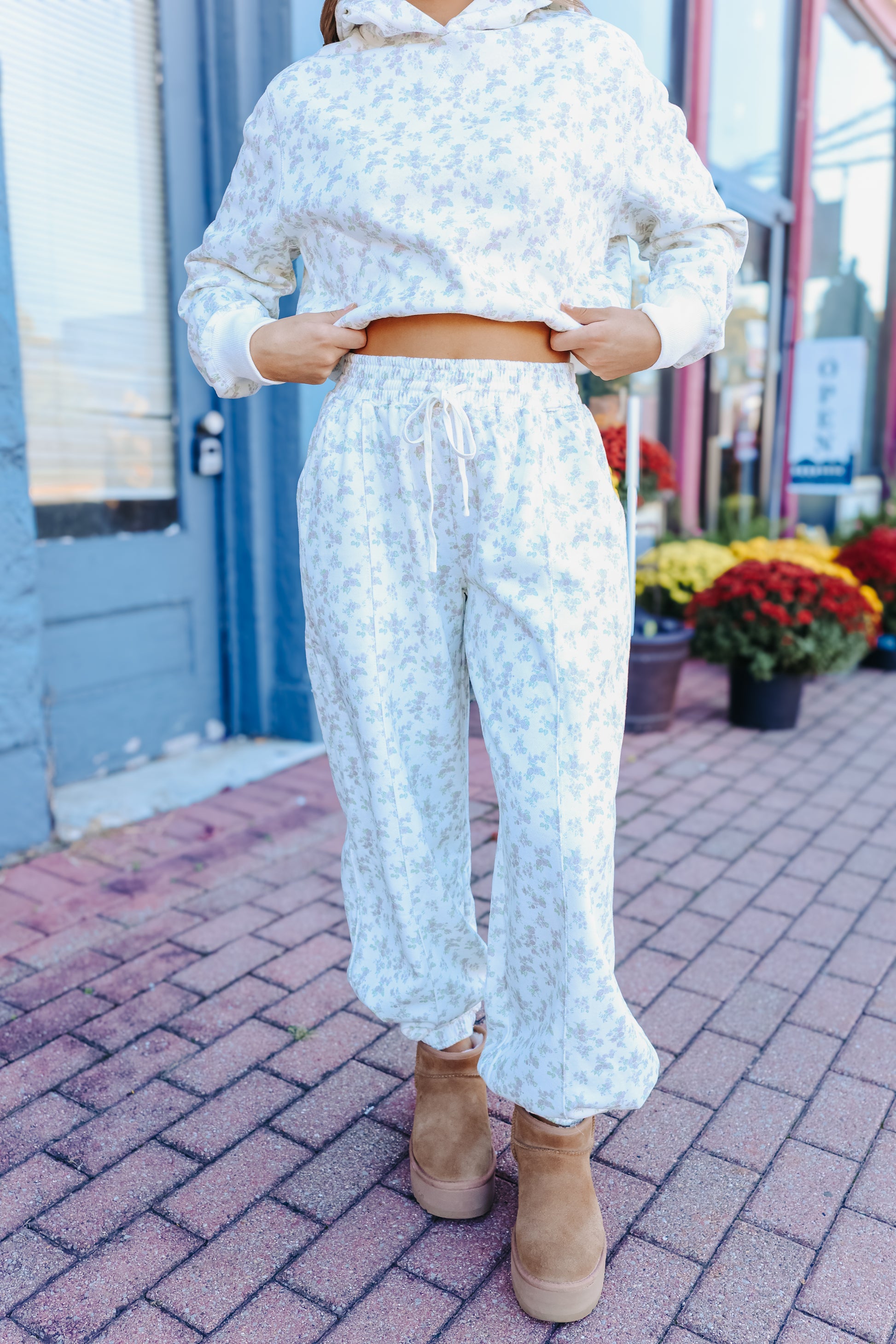 Model wearing blue floral joggers.