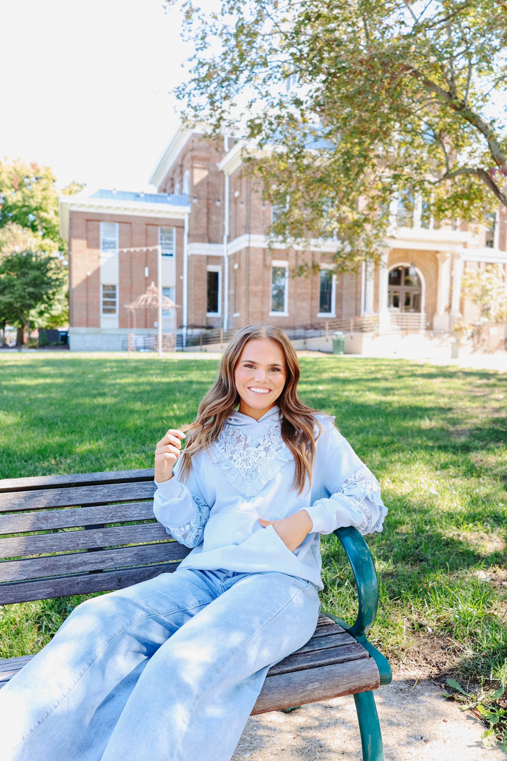 Model wearing light blue lace hoodie.