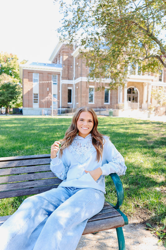 Model wearing light blue lace hoodie.