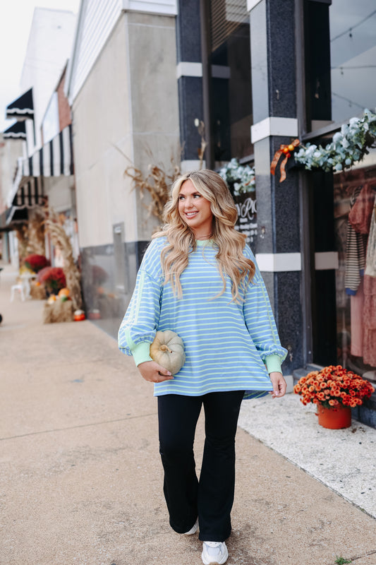 Blue and green striped oversized pullover top with contrast green sleeve stripes